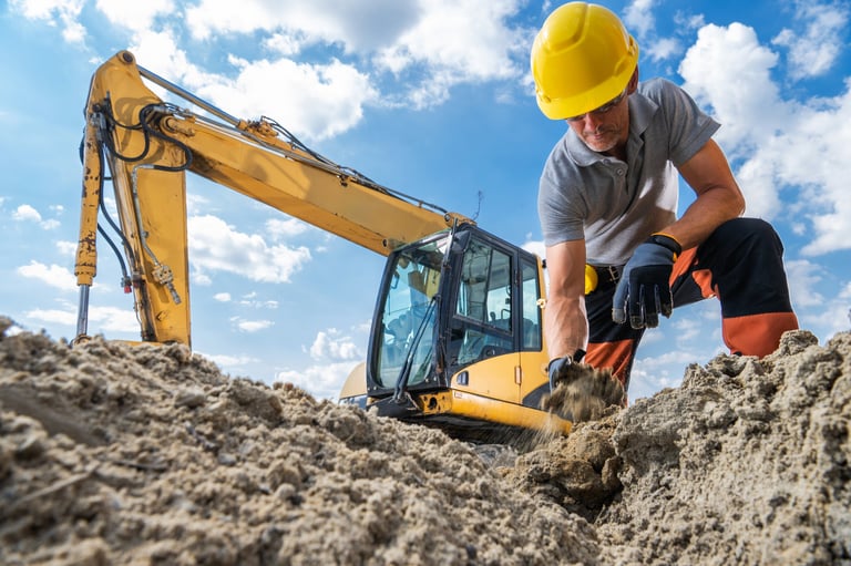 Construction worker using excavator