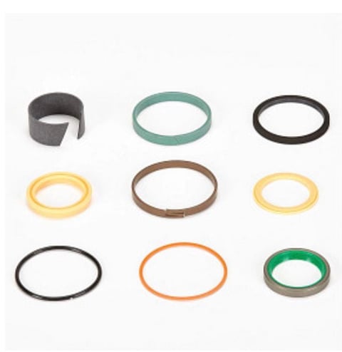 Nine colorful rubber bands and elastic rings arranged in a 3x3 grid, including gray, teal, black, yellow, brown, and orange options