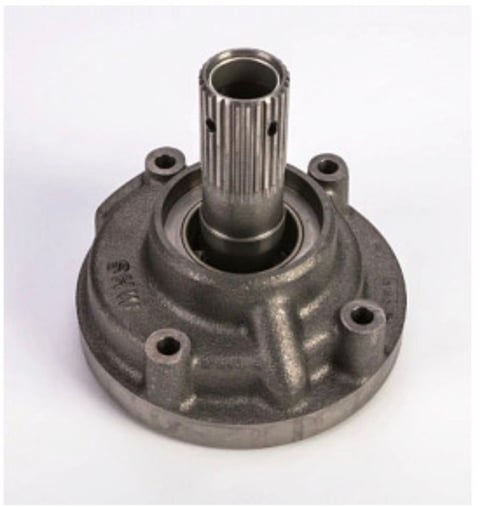 Metal automotive transmission component with central splined shaft and mounting holes on circular base
